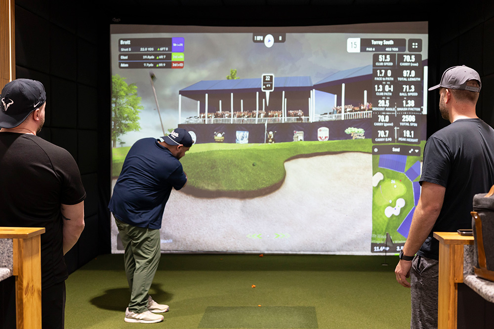 People playing indoor golf simulator at Keystone Golf Co in Wyomissing PA